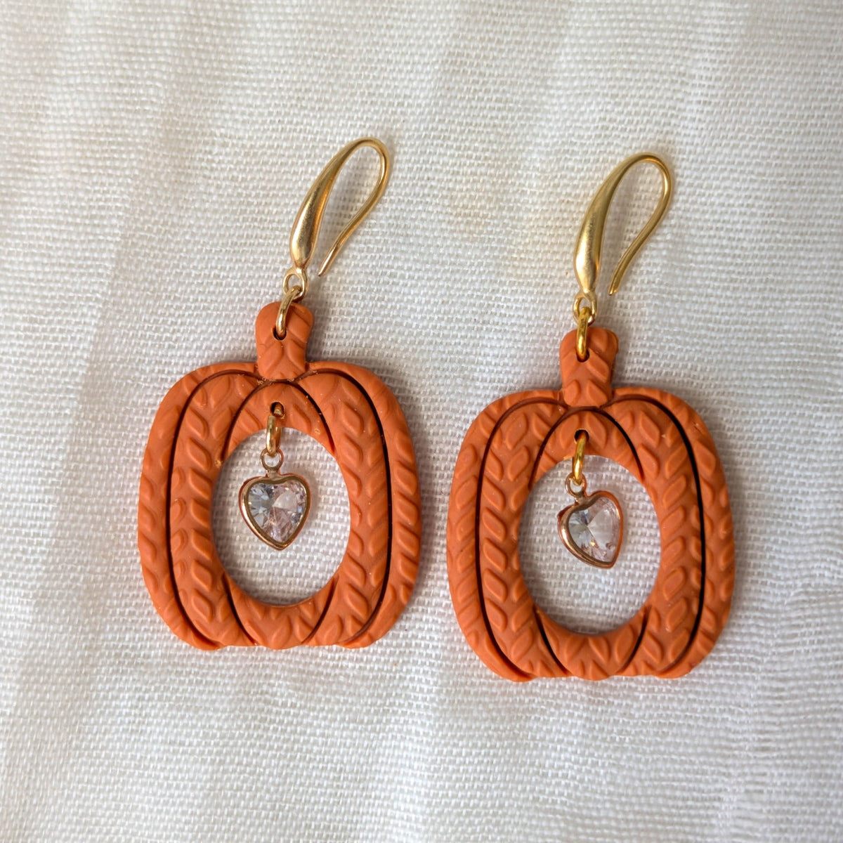 Burnt Orange knitted pumpkin earrings with clear heart charms and 14K gold-plated stainless steel hooks