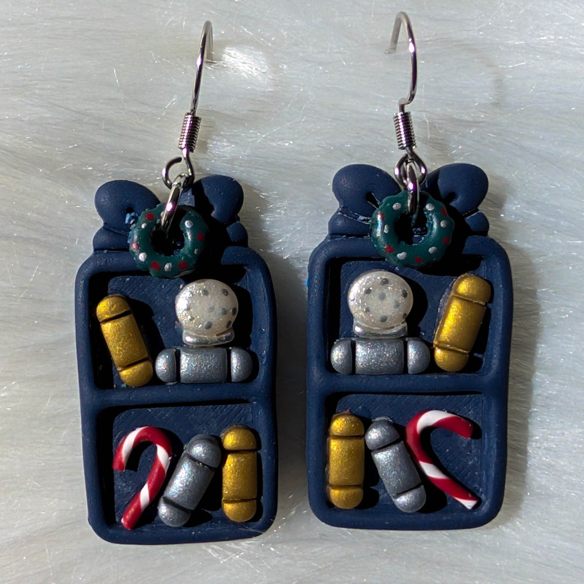 Midnight blue Christmas bookcase earrings with wreaths, snow globes, books and candy canes