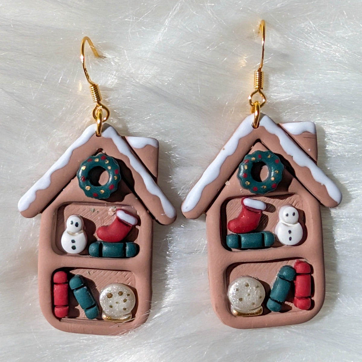 One-of-a-kind snowy cottage Christmas bookcase earrings with miniature books, snowmen and wreaths