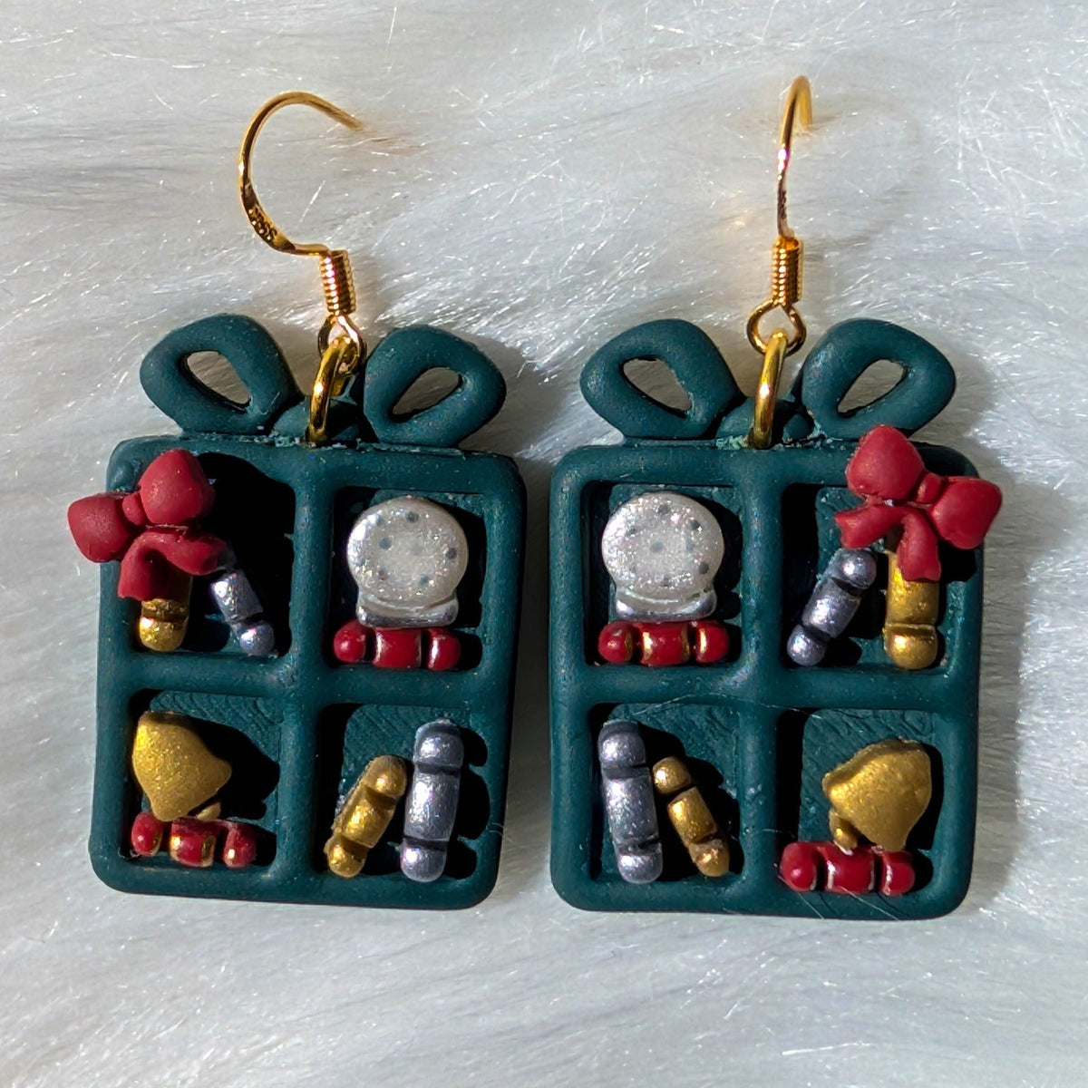 Teal Christmas bookcase earrings with bows, snow globes and gold-tone hooks