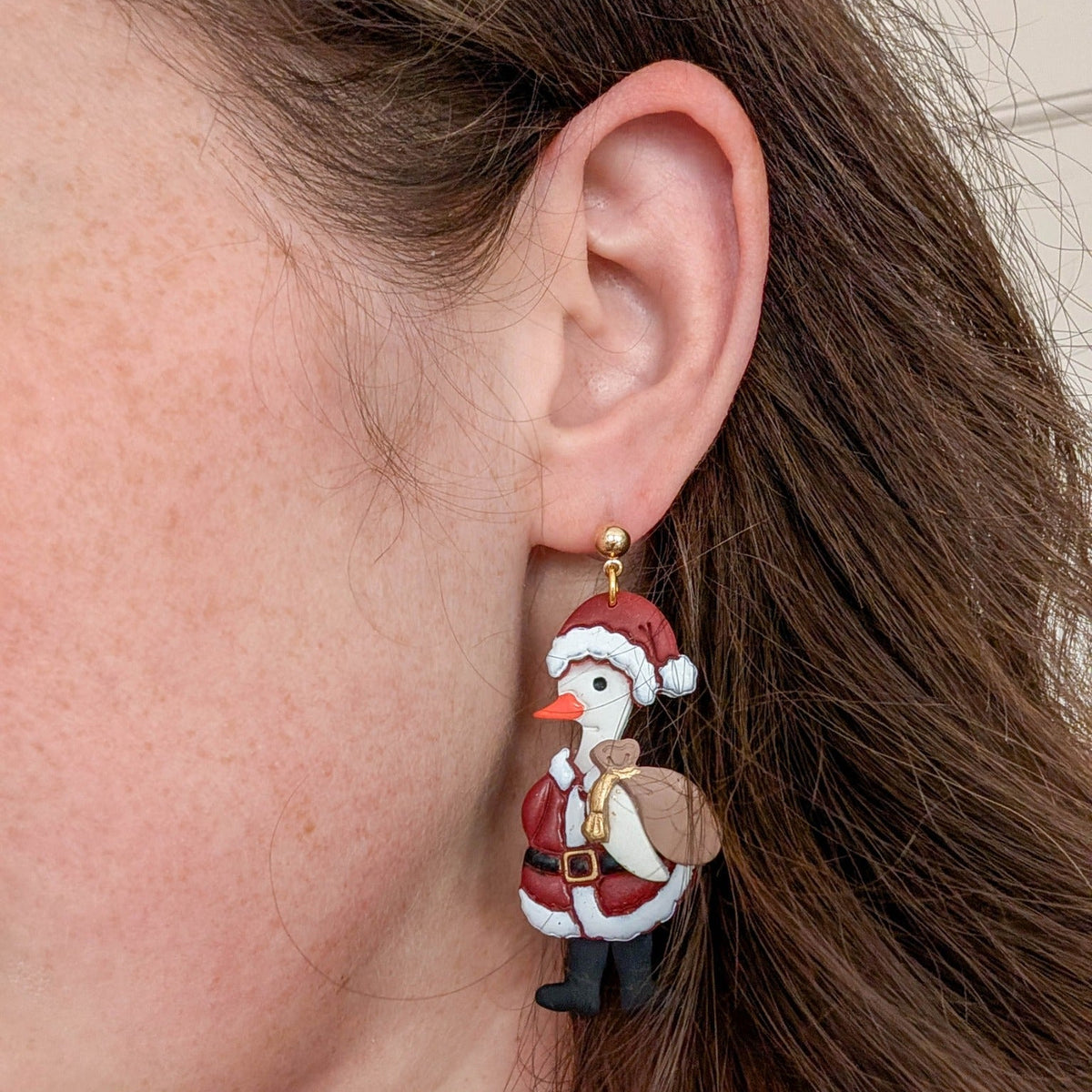 Santa Goose statement earring worn on ear, showing its 6 cm drop