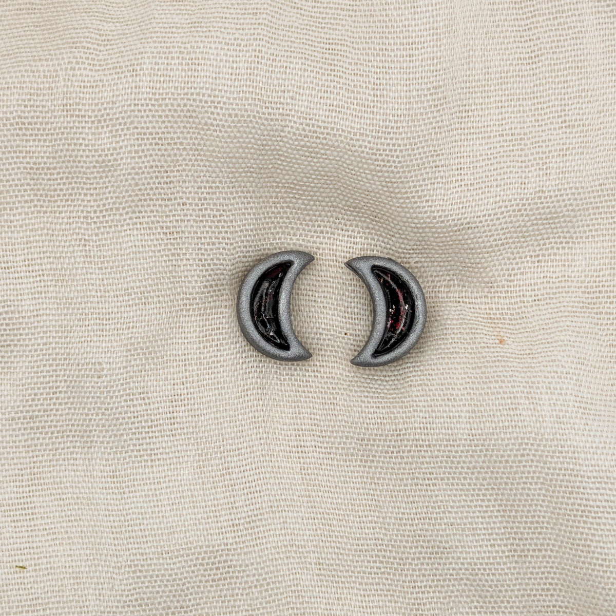 Silver crescent moon stud earrings with crimson and black vampire marble inlays