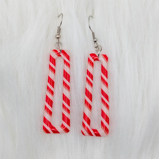 Long hollow candy cane striped dangle earrings in red, white, and translucent clay.