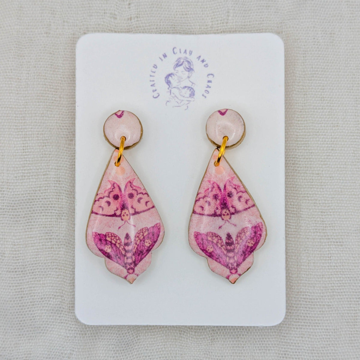 Pink moth pointed teardrop earrings with gold accents and glossy resin topcoat