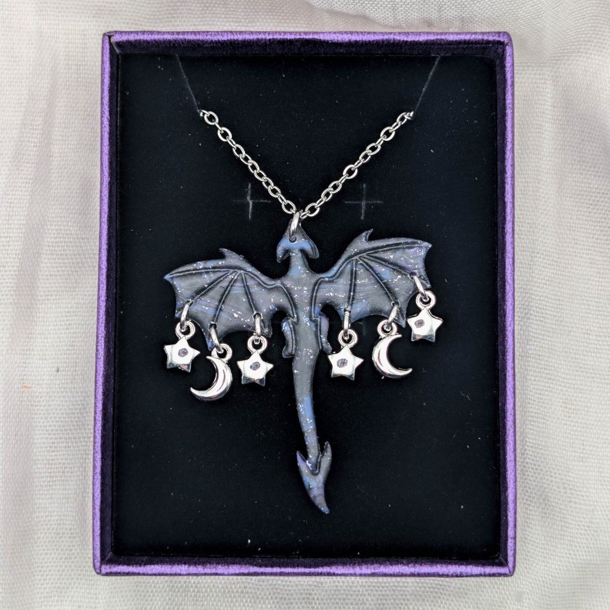 Marbled dragon necklace with silver chain and a garland of moon and star charms