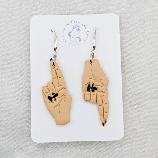 As Above, So Below golden tan hand earrings with black painted nails and silver-plated hooks