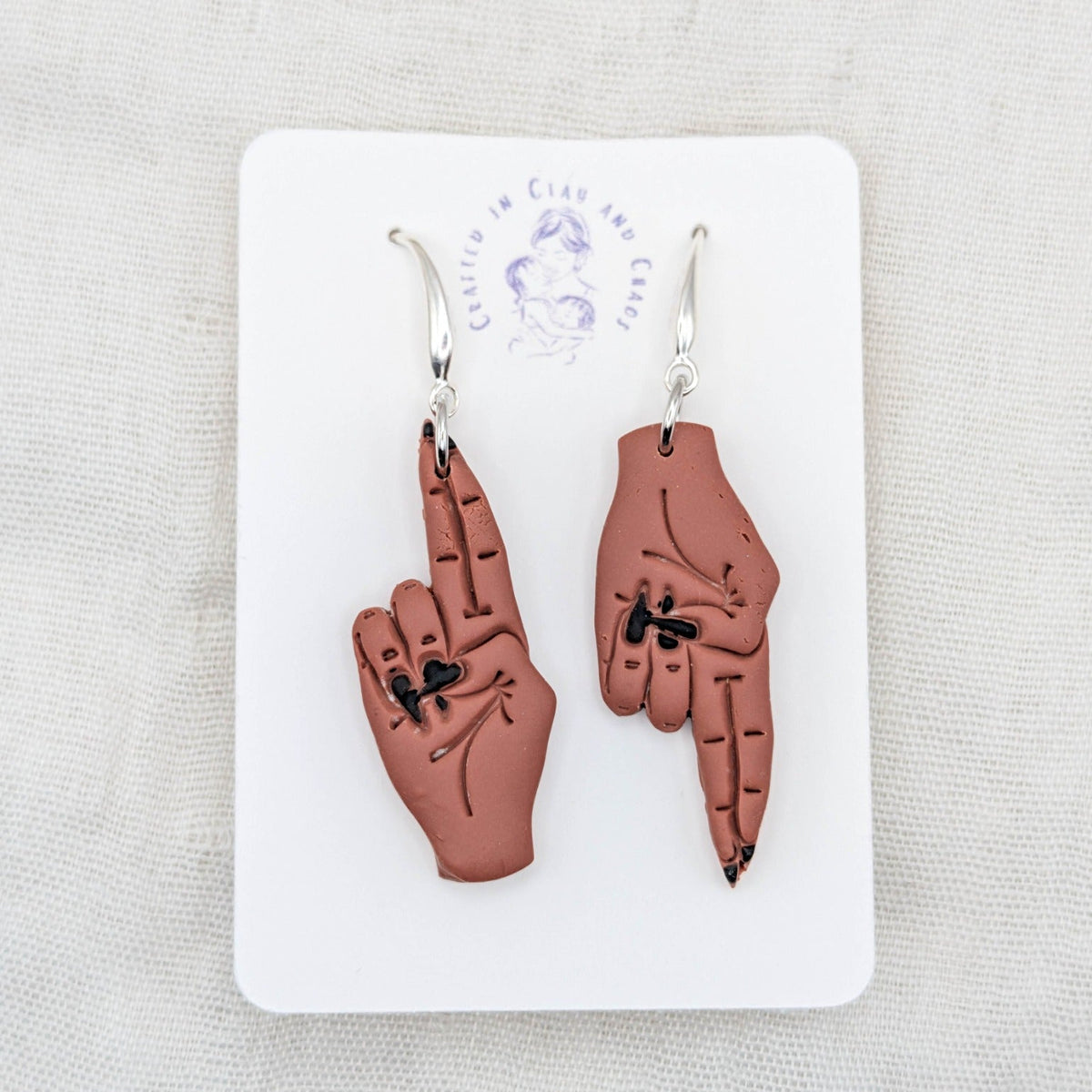 As Above, So Below warm terracotta hand earrings with black painted nails and silver-plated hooks