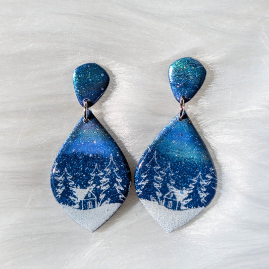 Diamond-shaped Aurora Borealis Christmas village polymer clay earrings in shimmering blue and white