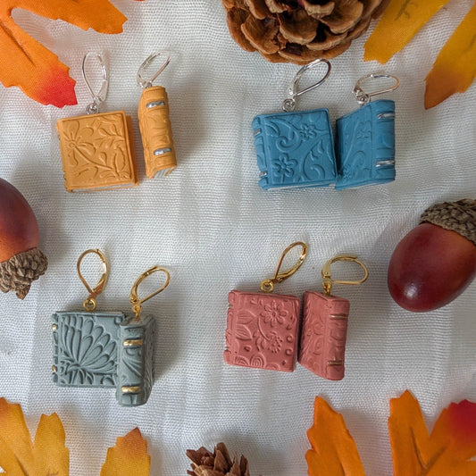 Embossed autumn book earrings in Mustard Yellow, Vintage Blue, Sage Green, and Dusty Terracotta