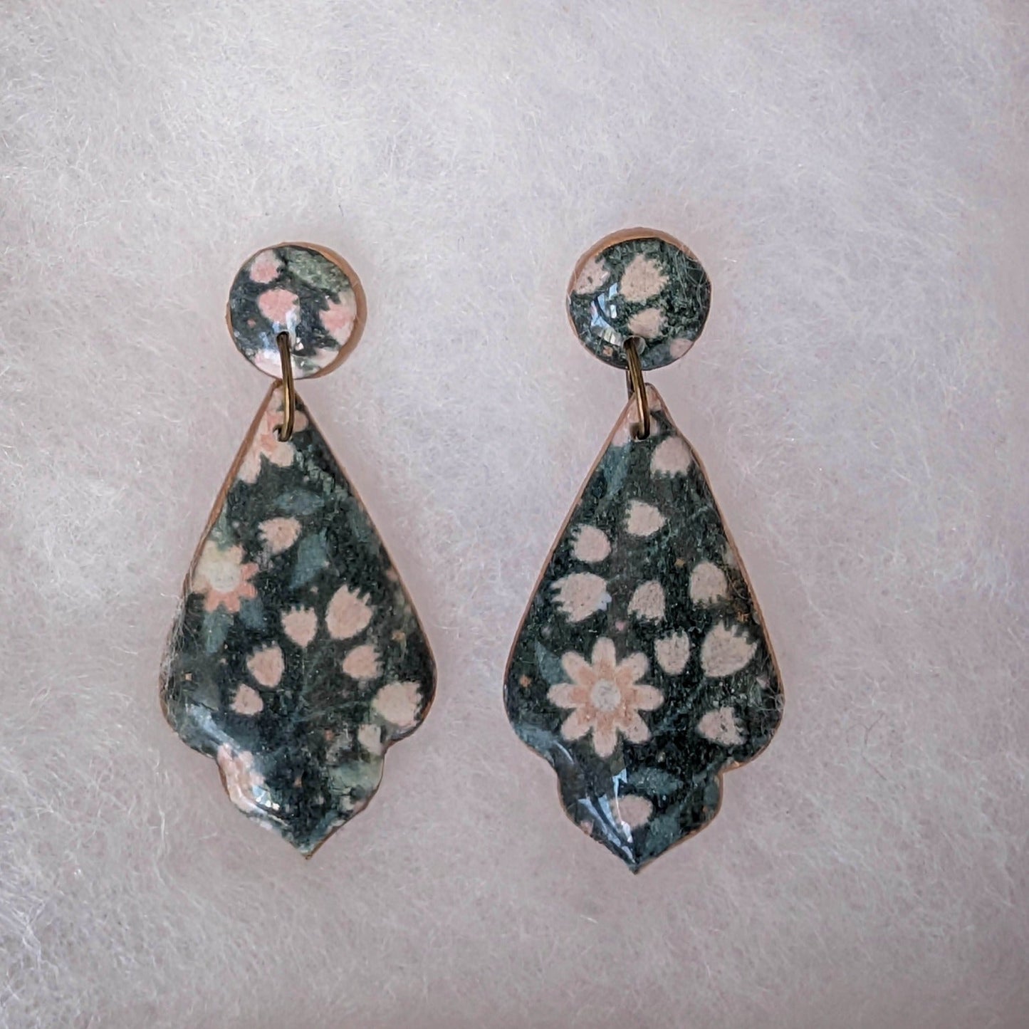Black moth gothic teardrop earrings with pale pink floral pattern and copper-toned edging