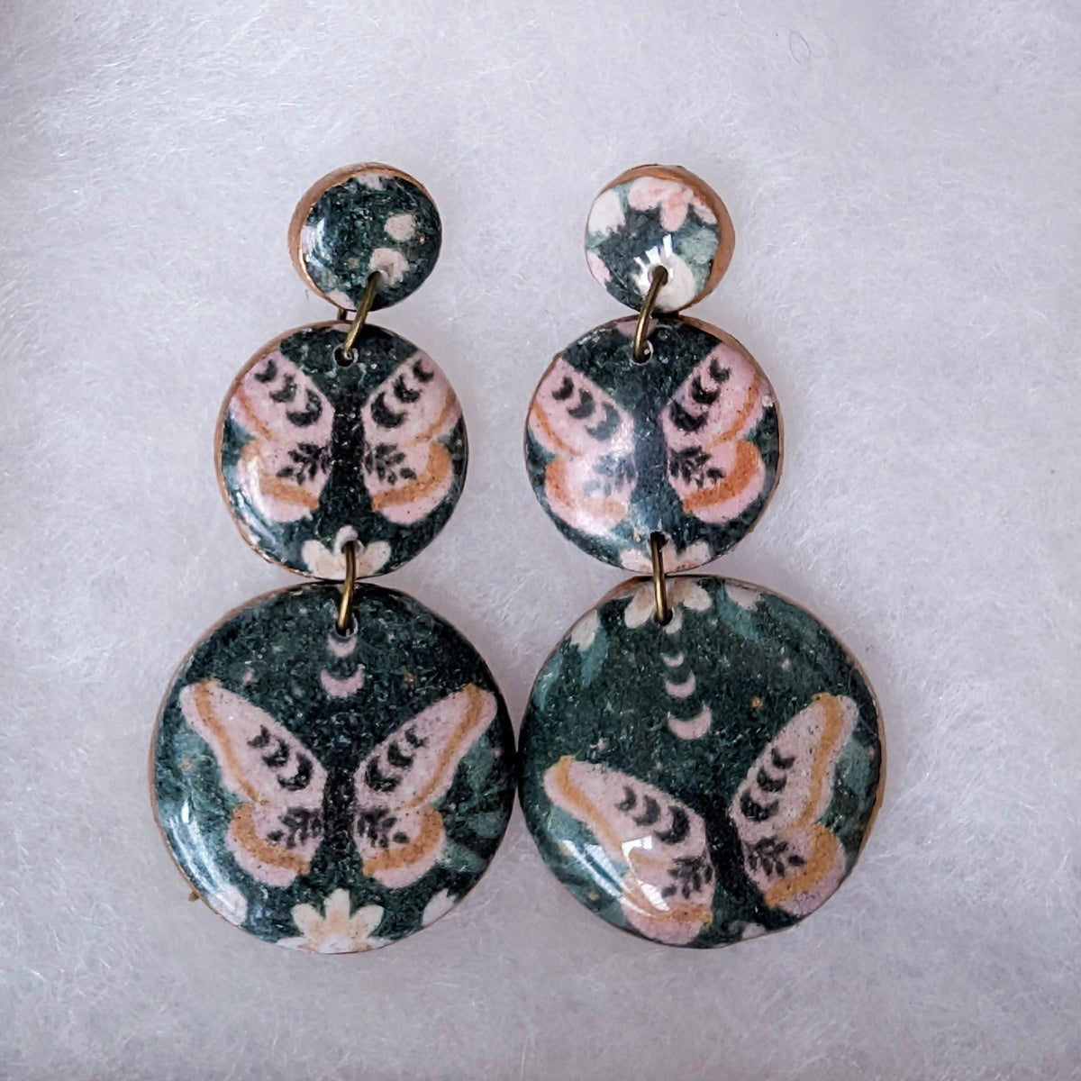 Black moth triple circle statement earrings with pink flowers and copper-toned edging