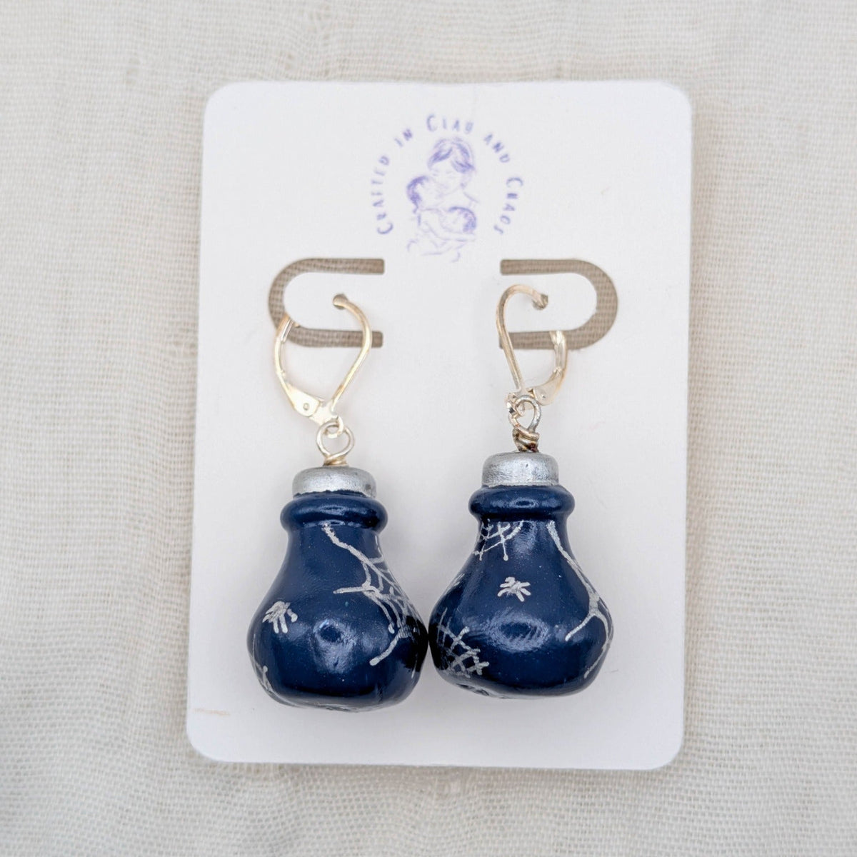 Deep blue handmade 3D potion bottle earrings with hand-drawn silver spiders and cobwebs on silver-plated leverbacks