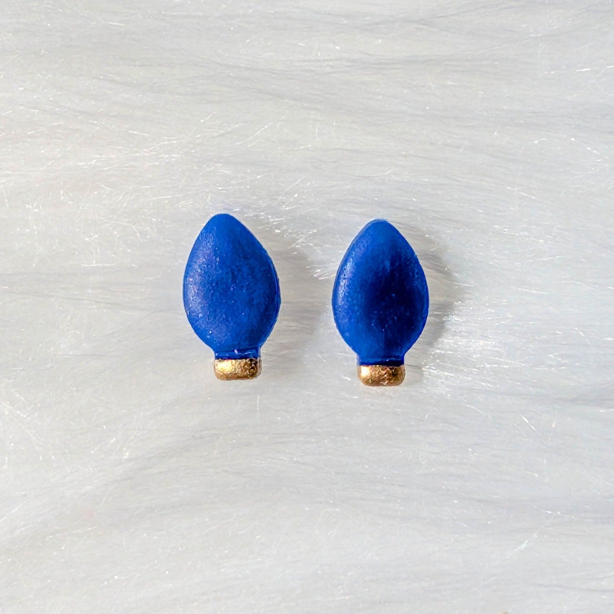 Blue Christmas light bulb stud earrings with a gold metallic finish