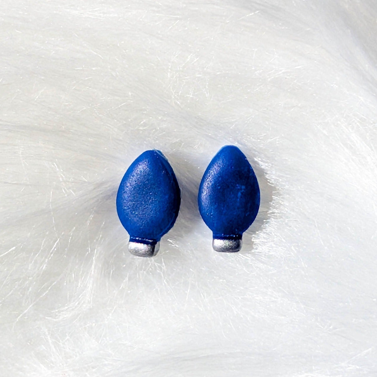 Blue Christmas light bulb stud earrings with a silver metallic finish