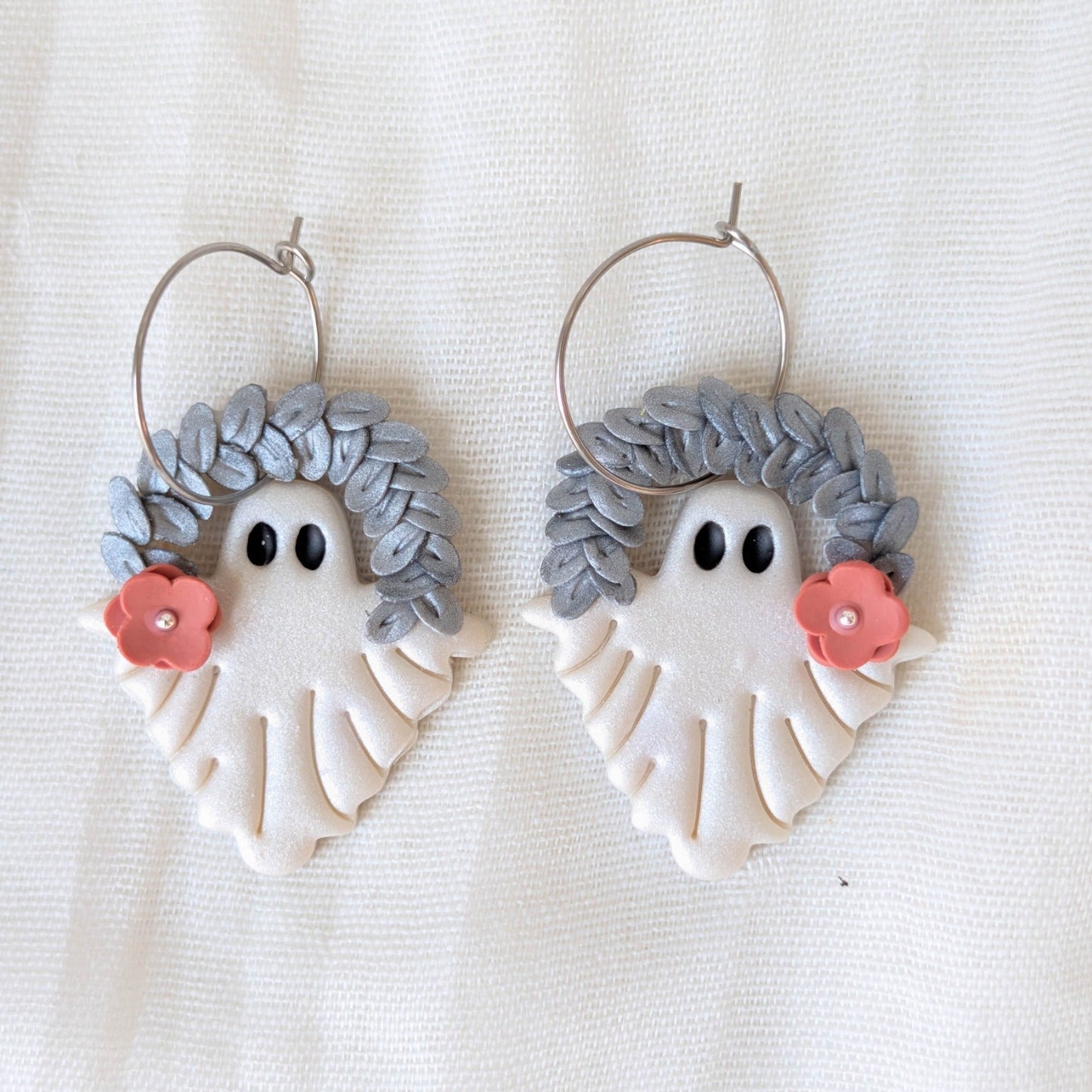 Pearlescent botanical ghost earrings with silver leaf crowns, coral flowers, and surgical-grade stainless steel hoops