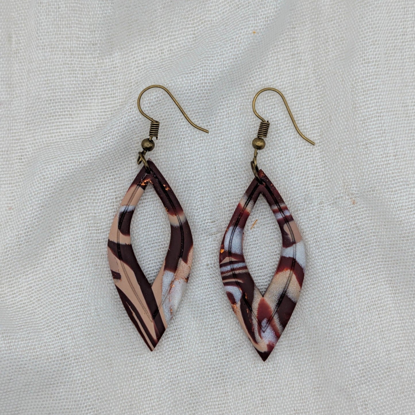Brown marble feather earrings with antique bronze hooks and open marquise shape