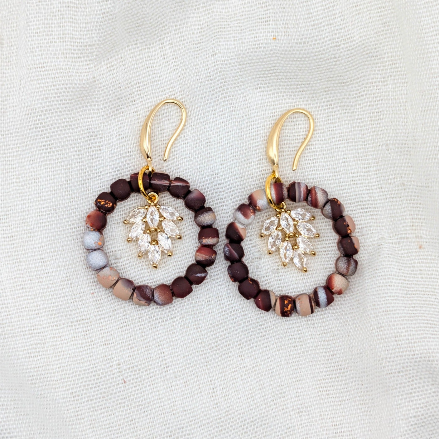 Brown marble wreath dangle earrings with gold hooks and sparkling leaf cluster centers