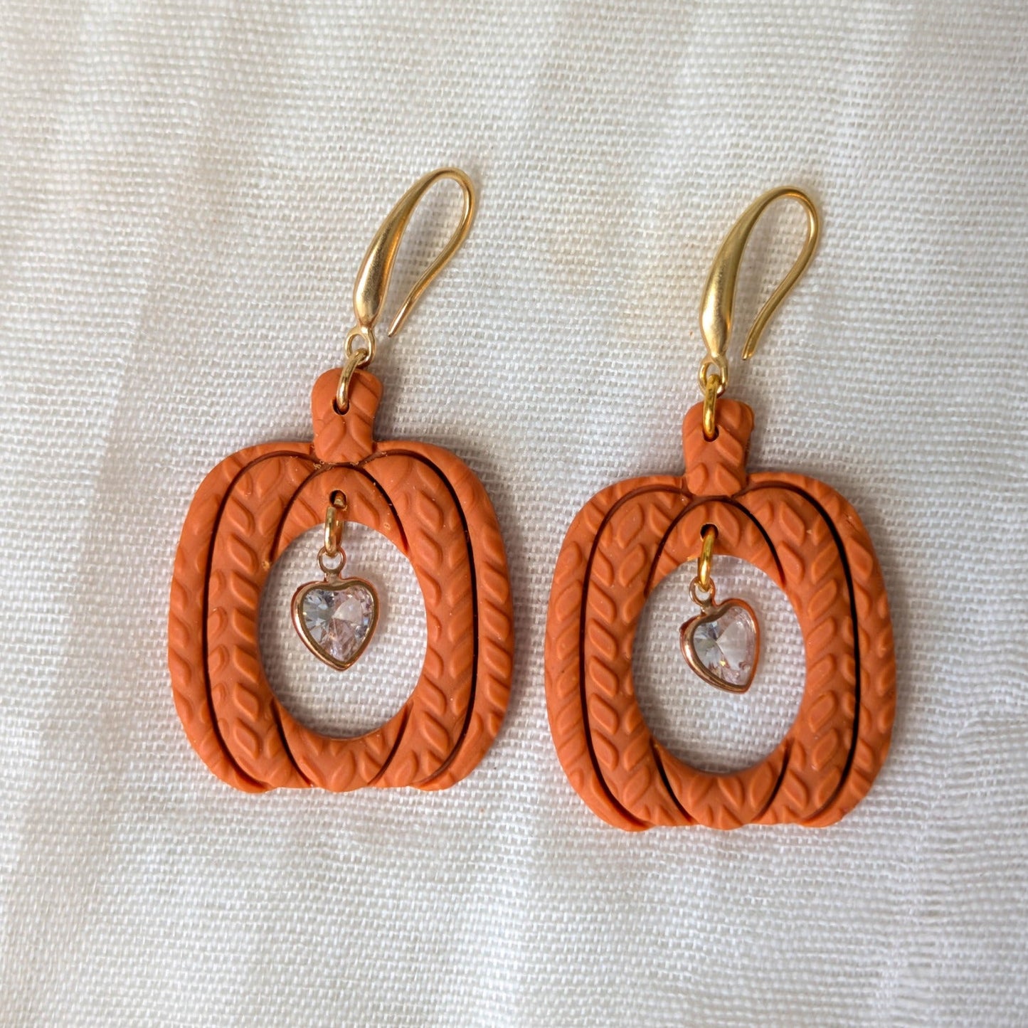 Burnt Orange knitted pumpkin earrings with clear heart charms and 14K gold-plated stainless steel hooks