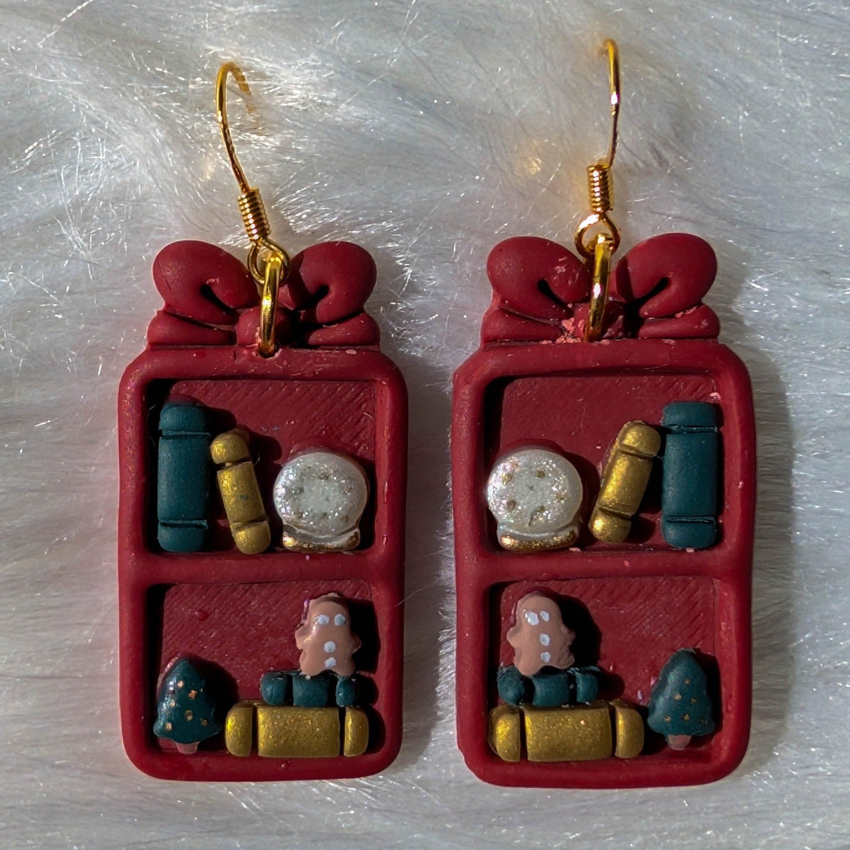 Berry red Christmas bookcase earrings with a bow, books, snow globe, trees and gingerbread details