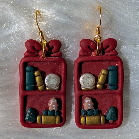 Berry red Christmas bookcase earrings with a bow, books, snow globe, trees and gingerbread details