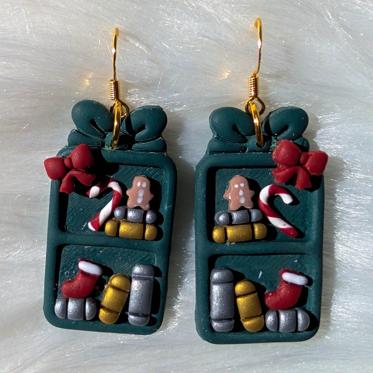 Teal Christmas bookcase earrings with gingerbread figures, stockings, bows and books