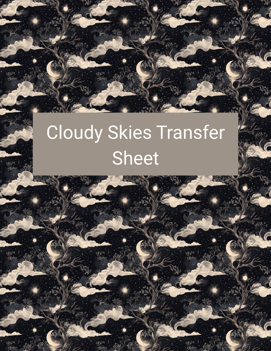 Cloudy Skies polymer clay transfer paper with black, midnight navy, ivory cream, smoky gray, and soft gold featuring billowing cream clouds, crescent moons, stars, and swirling night-sky details