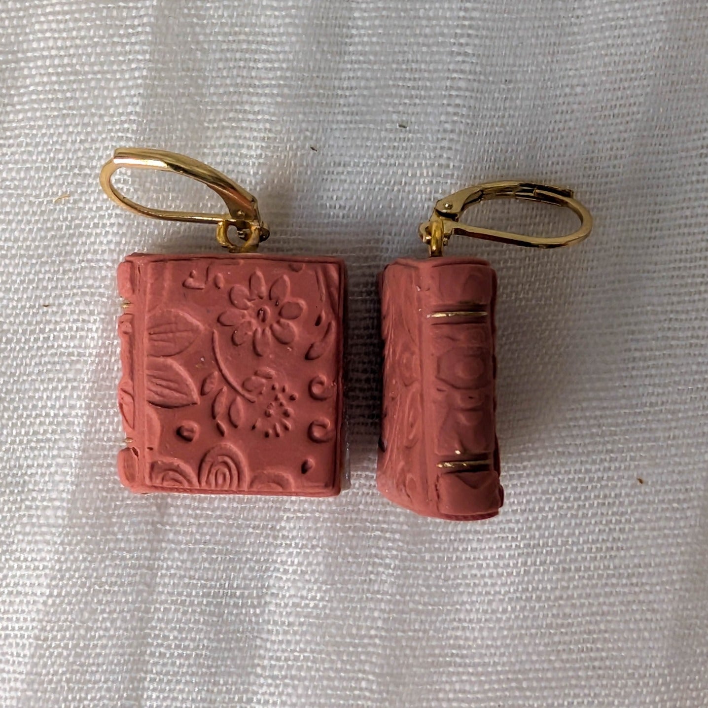 Embossed Dusty Terracotta book earrings with floral details, gold accents, and gold findings