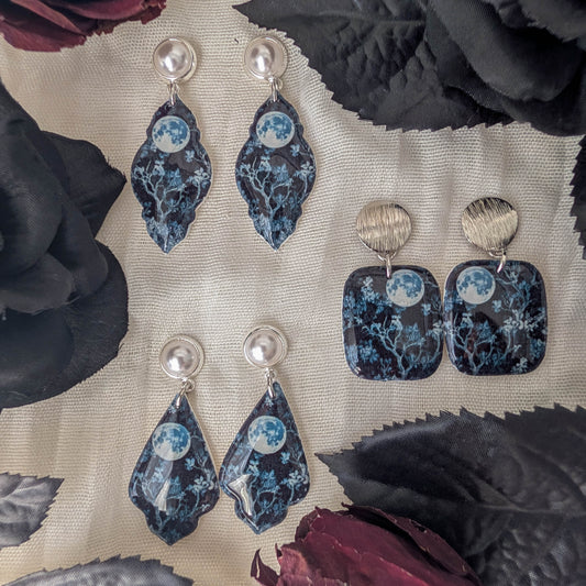 Blue moon earrings in petal, square, and curvy frame styles with silver-toned findings