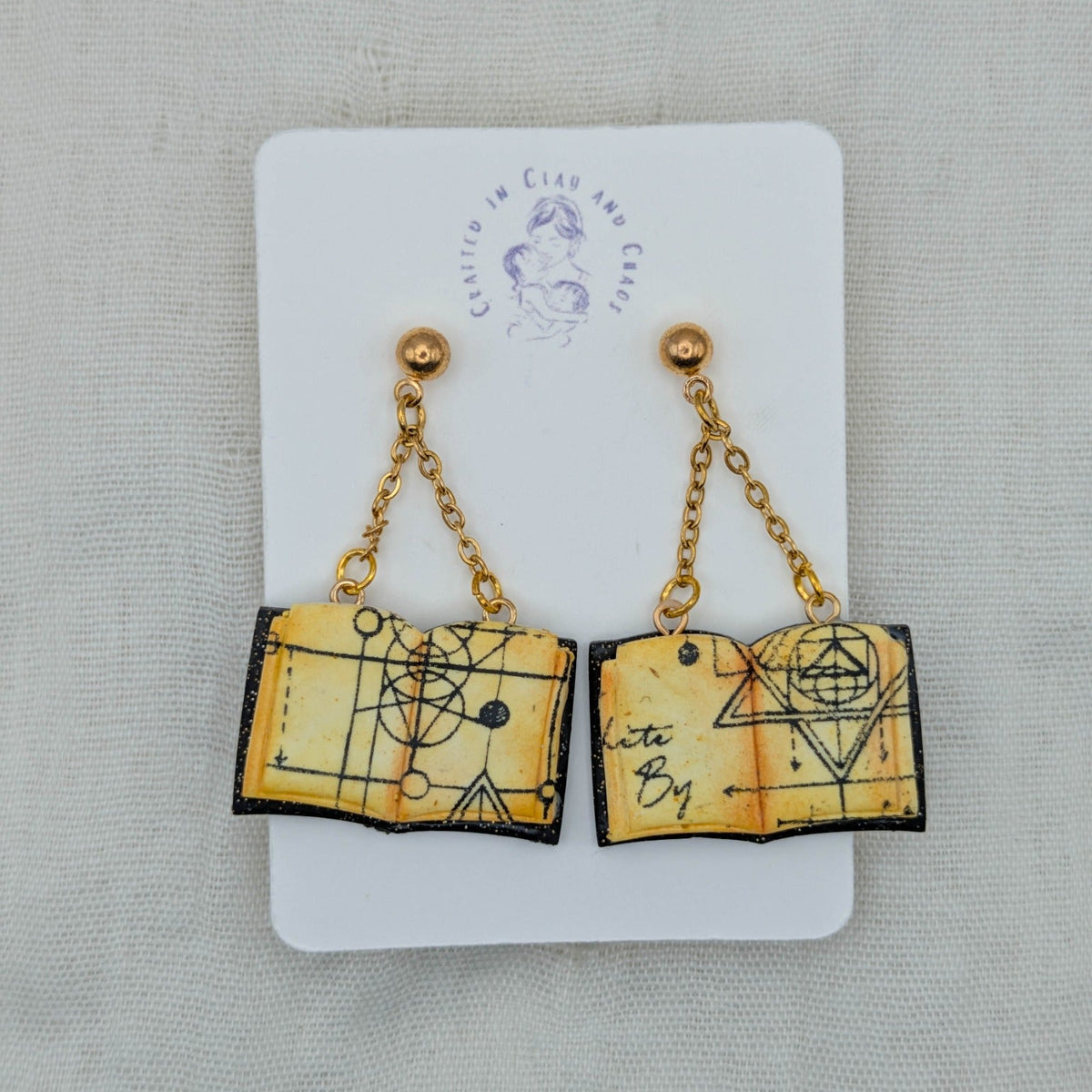 Black Sparkle open spellbook earrings with gold findings
