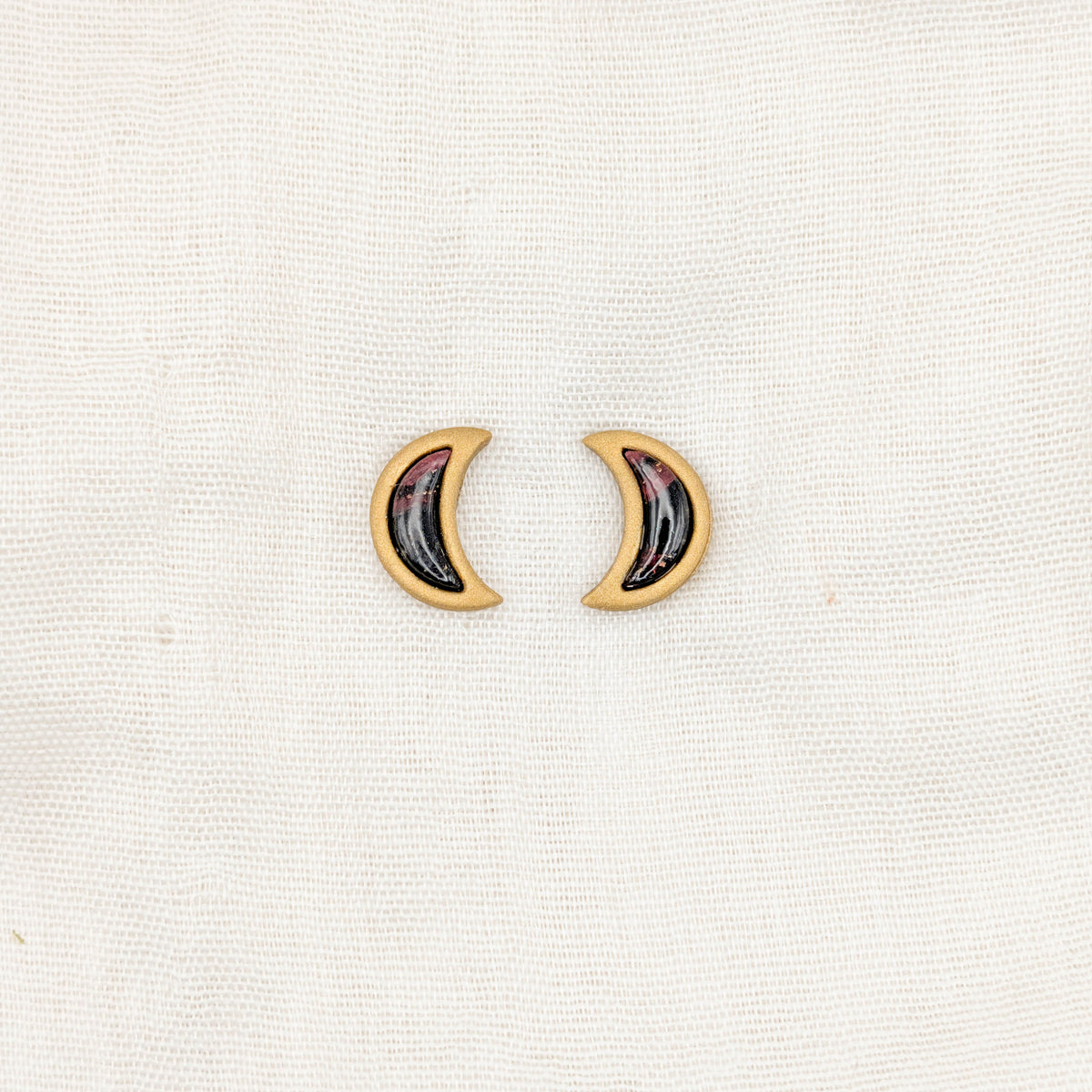Gold crescent moon stud earrings with crimson and black vampire marble inlays