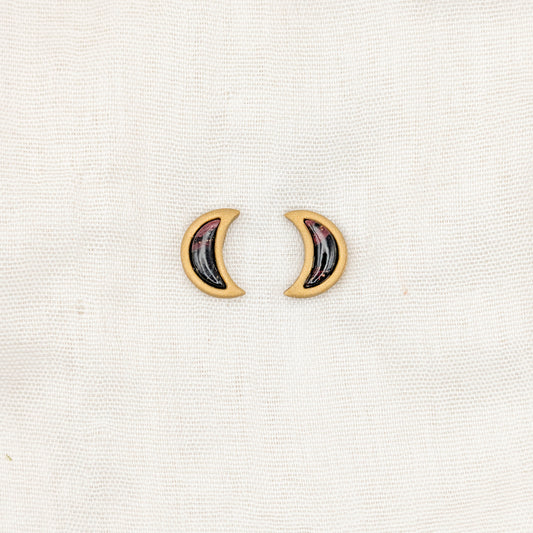 Gold crescent moon stud earrings with crimson and black vampire marble inlays