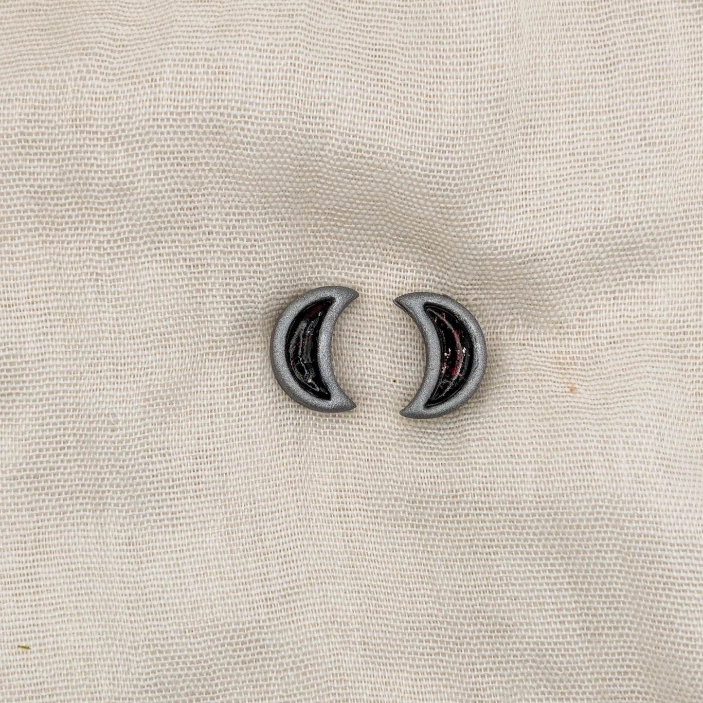 Silver crescent moon stud earrings with crimson and black vampire marble inlays