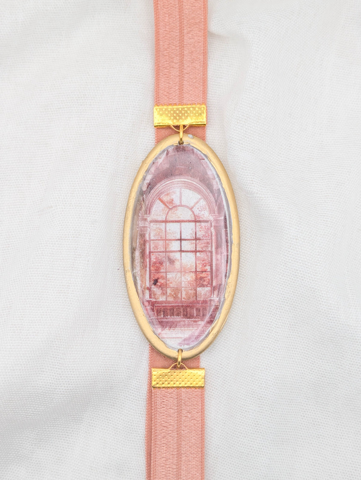 Gold framed fall polymer clay wrap-around bookmark with an arched window scene and blush elastic band