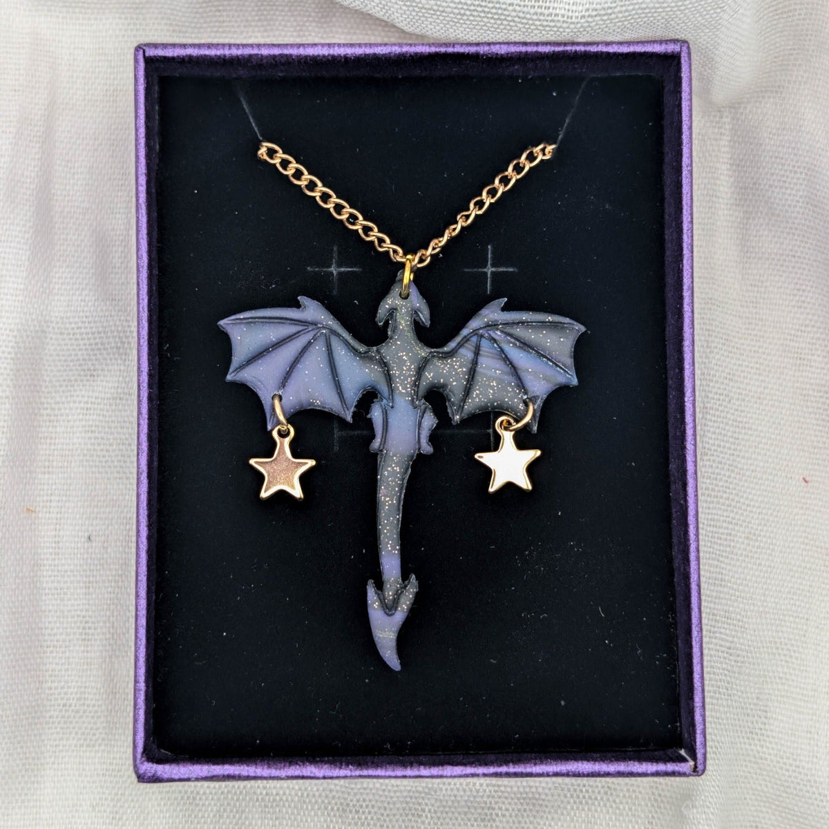 Marbled fantasy dragon necklace with gold chain and two large star charms