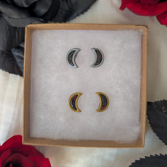Gold and silver mirrored crescent moon stud earrings with crimson and black vampire marble inlays