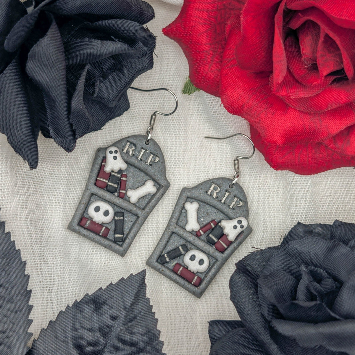 Handmade gray gravestone bookcase Halloween earrings with books, ghosts, bones, skulls, and RIP lettering