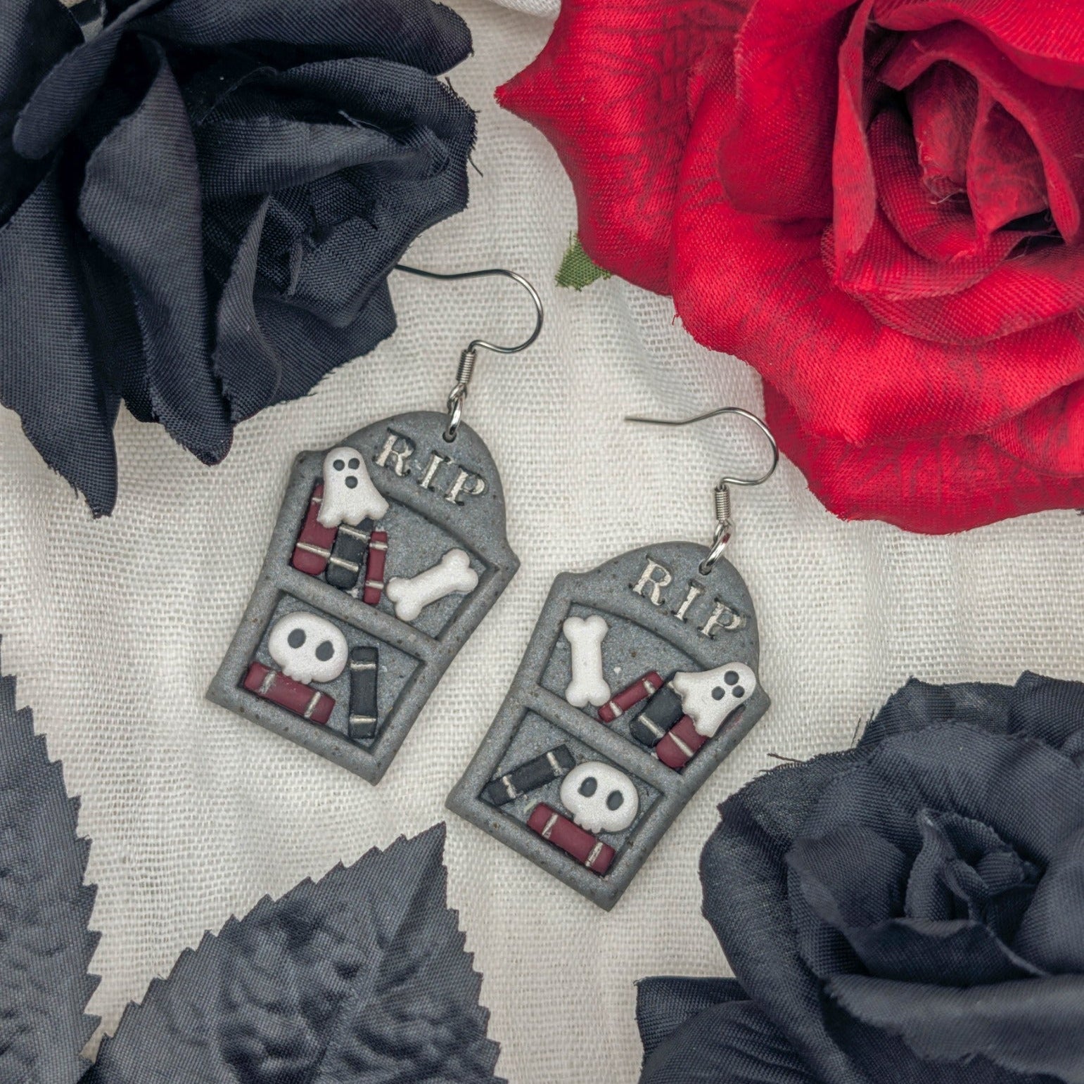 Handmade gray gravestone bookcase Halloween earrings with books, ghosts, bones, skulls, and RIP lettering