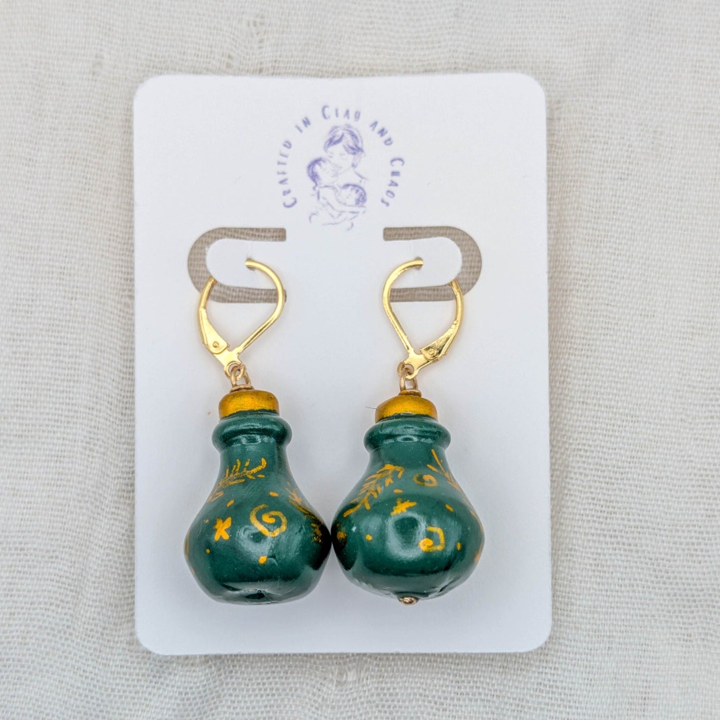 Green handmade 3D potion bottle earrings with hand-drawn gold symbols and 18K gold-plated stainless steel leverbacks