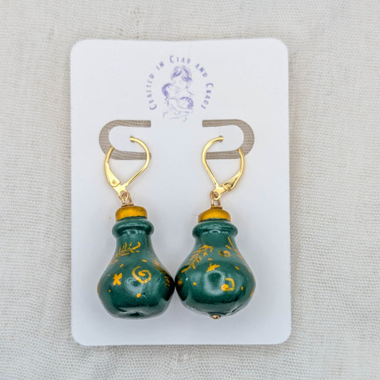 Green handmade 3D potion bottle earrings with hand-drawn gold symbols and 18K gold-plated stainless steel leverbacks