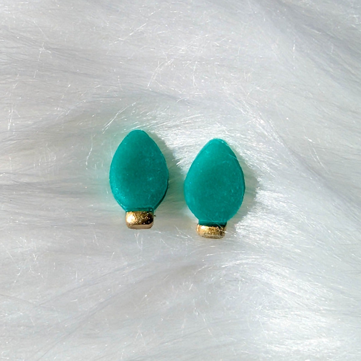 Green Christmas light bulb stud earrings with a gold metallic finish