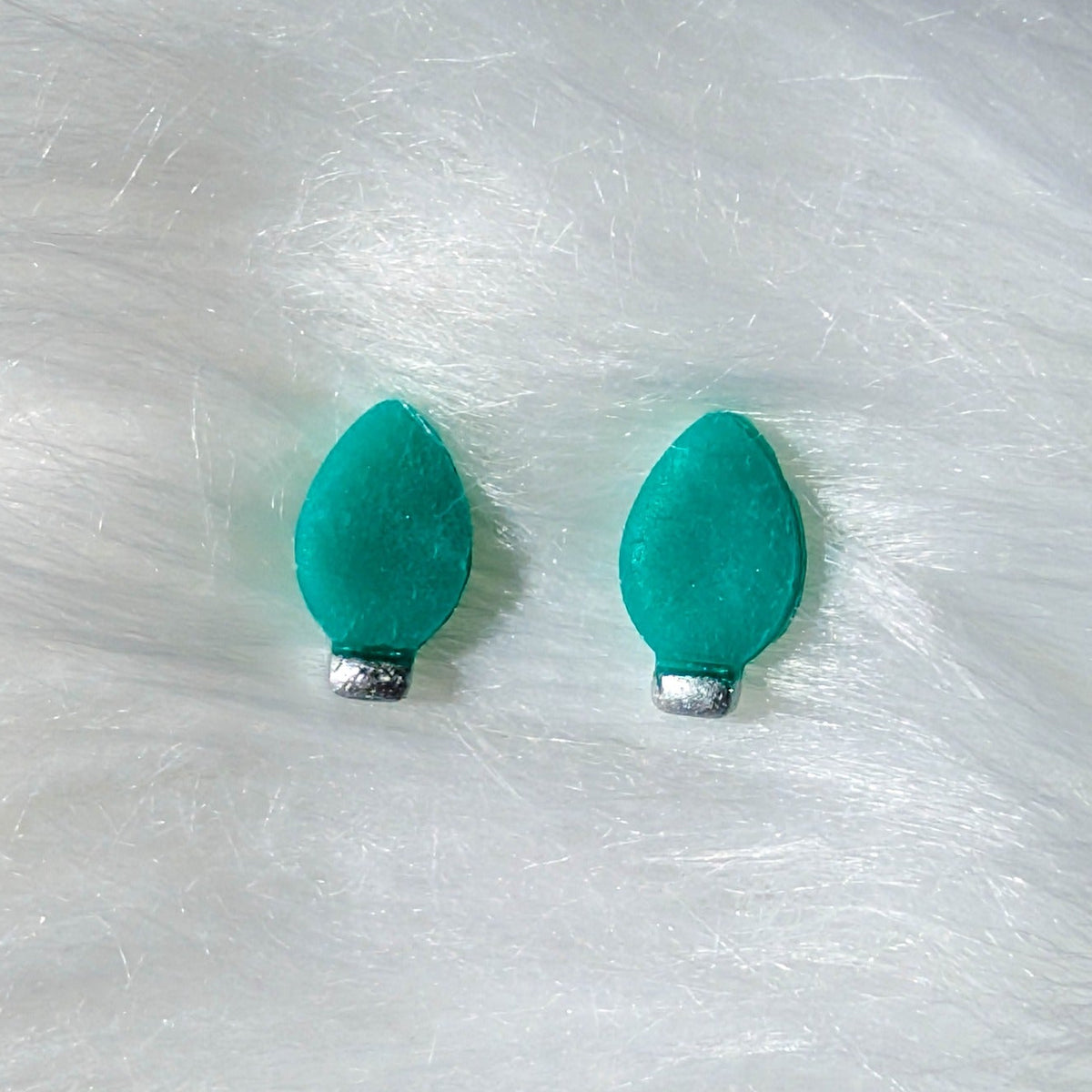 Green Christmas light bulb stud earrings with a silver metallic finish