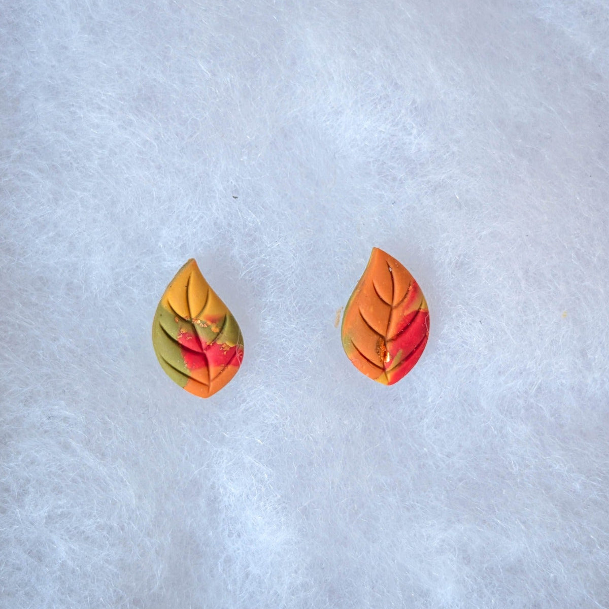 Multicolor marbled fall leaf stud earrings in red, orange, yellow, and green