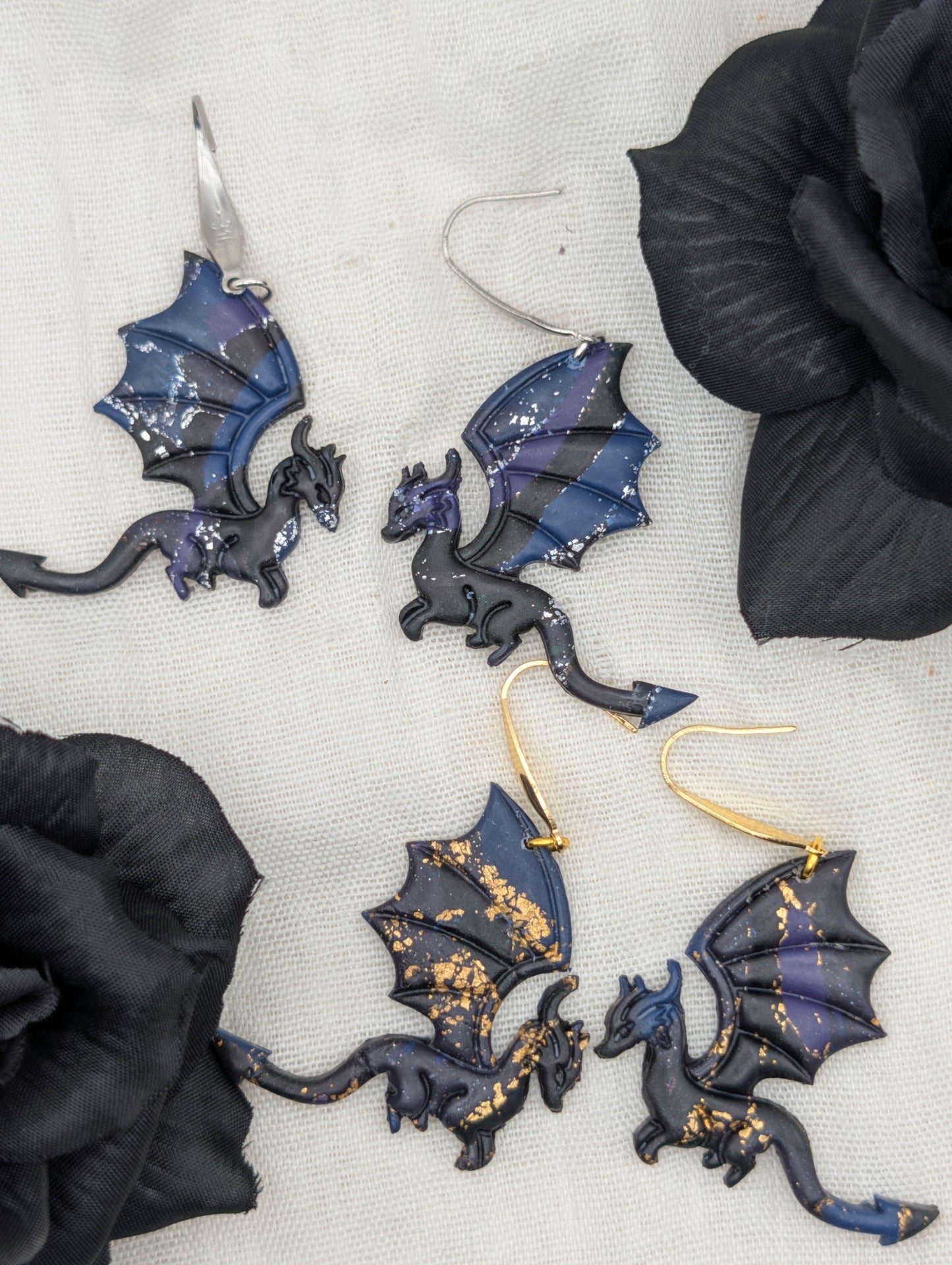 Gold- and silver-flecked midnight marble dragon earrings styled with black flowers, showing large hook options