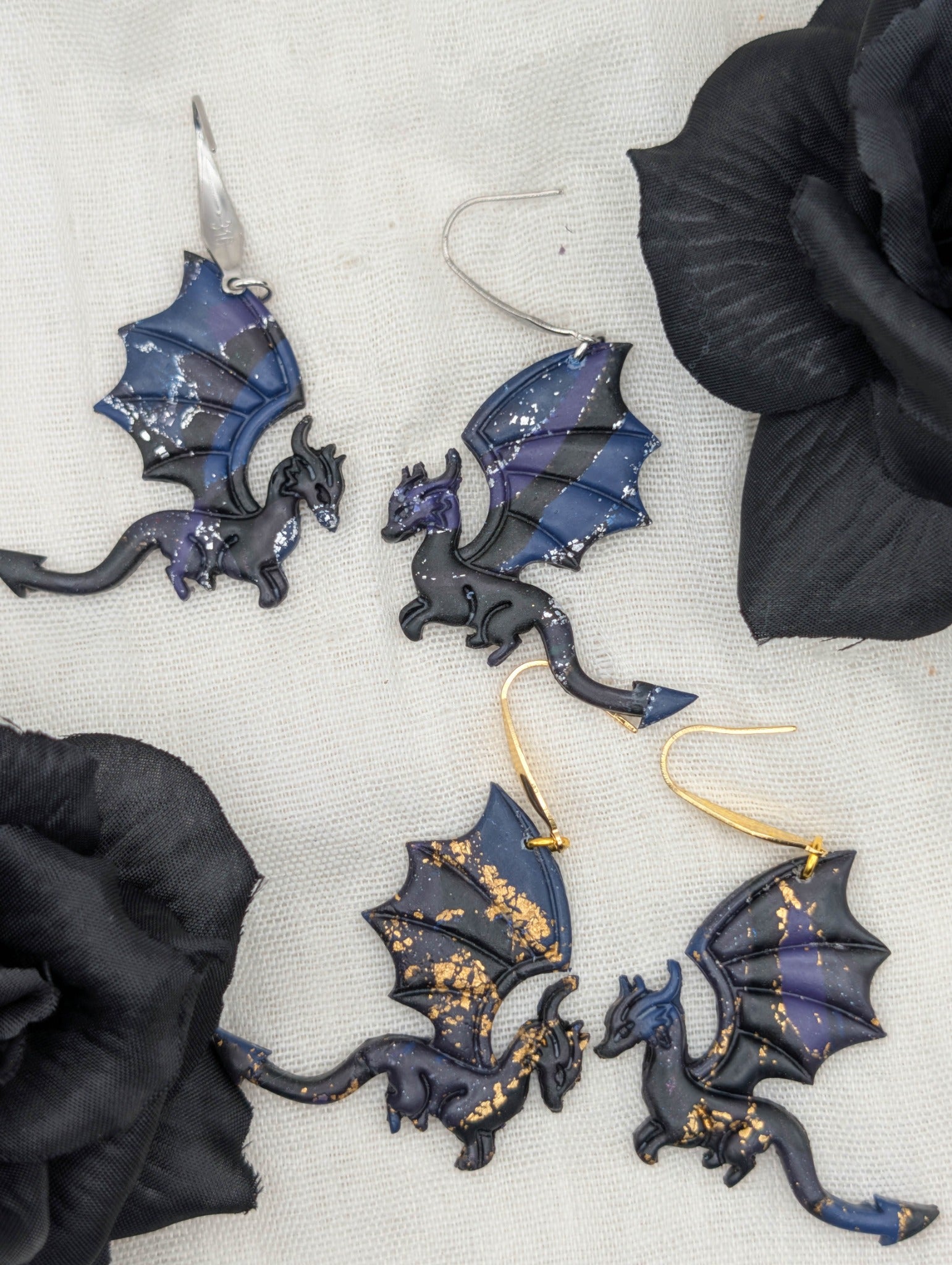 Gold- and silver-flecked midnight marble dragon earrings styled with black flowers, showing large hook options