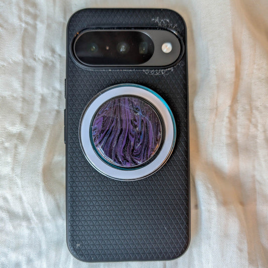 Midnight marble MagSafe phone grip with clear base displayed on a black smartphone
