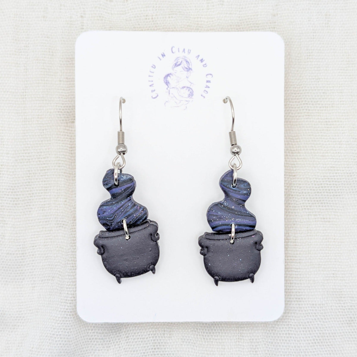 Midnight blue and purple marbled potion smoke earrings with deep purple cauldrons and surgical-grade stainless steel hooks