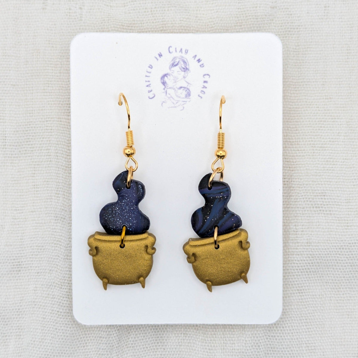 Midnight blue marbled potion smoke earrings with metallic gold cauldrons and 18K gold-plated stainless steel hooks