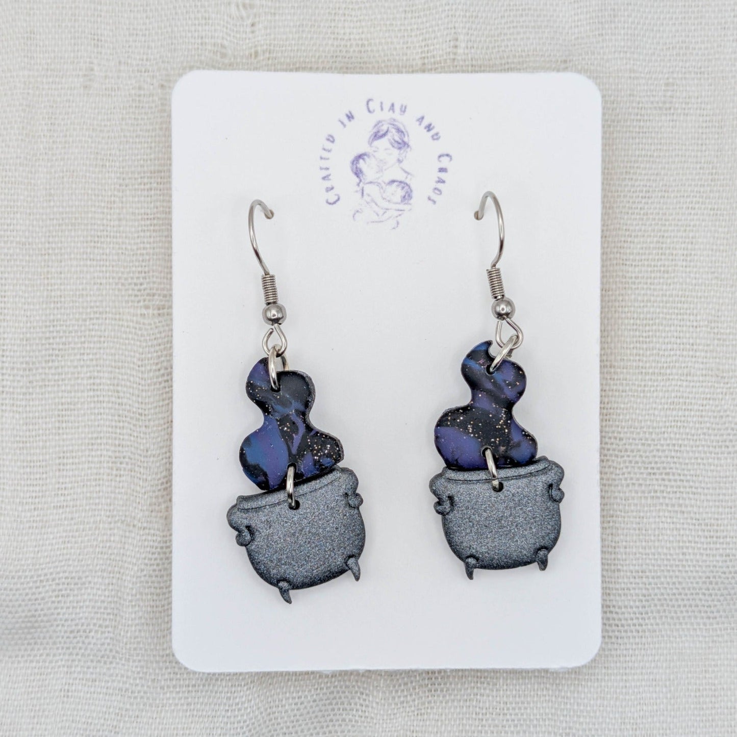 Midnight blue and purple marbled potion smoke earrings with shimmering gray cauldrons and surgical-grade stainless steel hooks