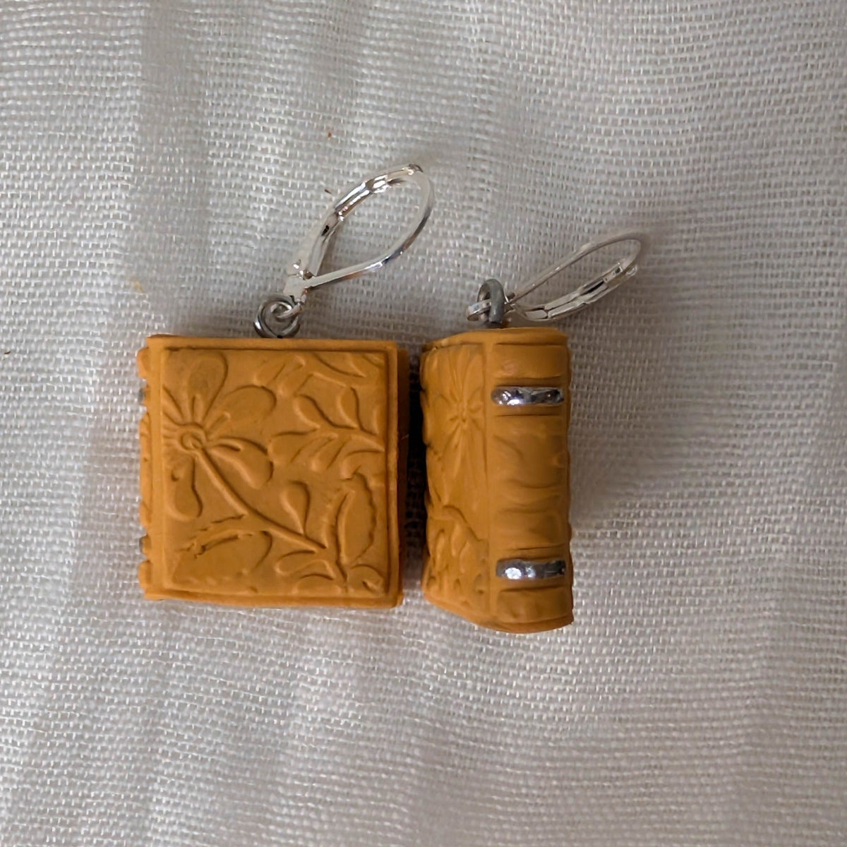 Embossed Mustard Yellow book earrings with floral details, silver accents, and silver findings