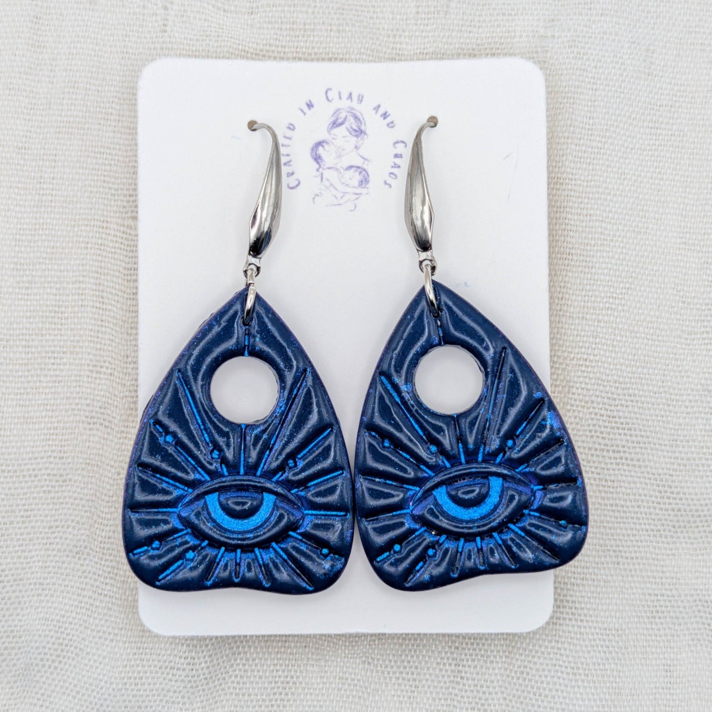Blue planchette earrings with bright blue all-seeing eye details and surgical-grade stainless steel hooks